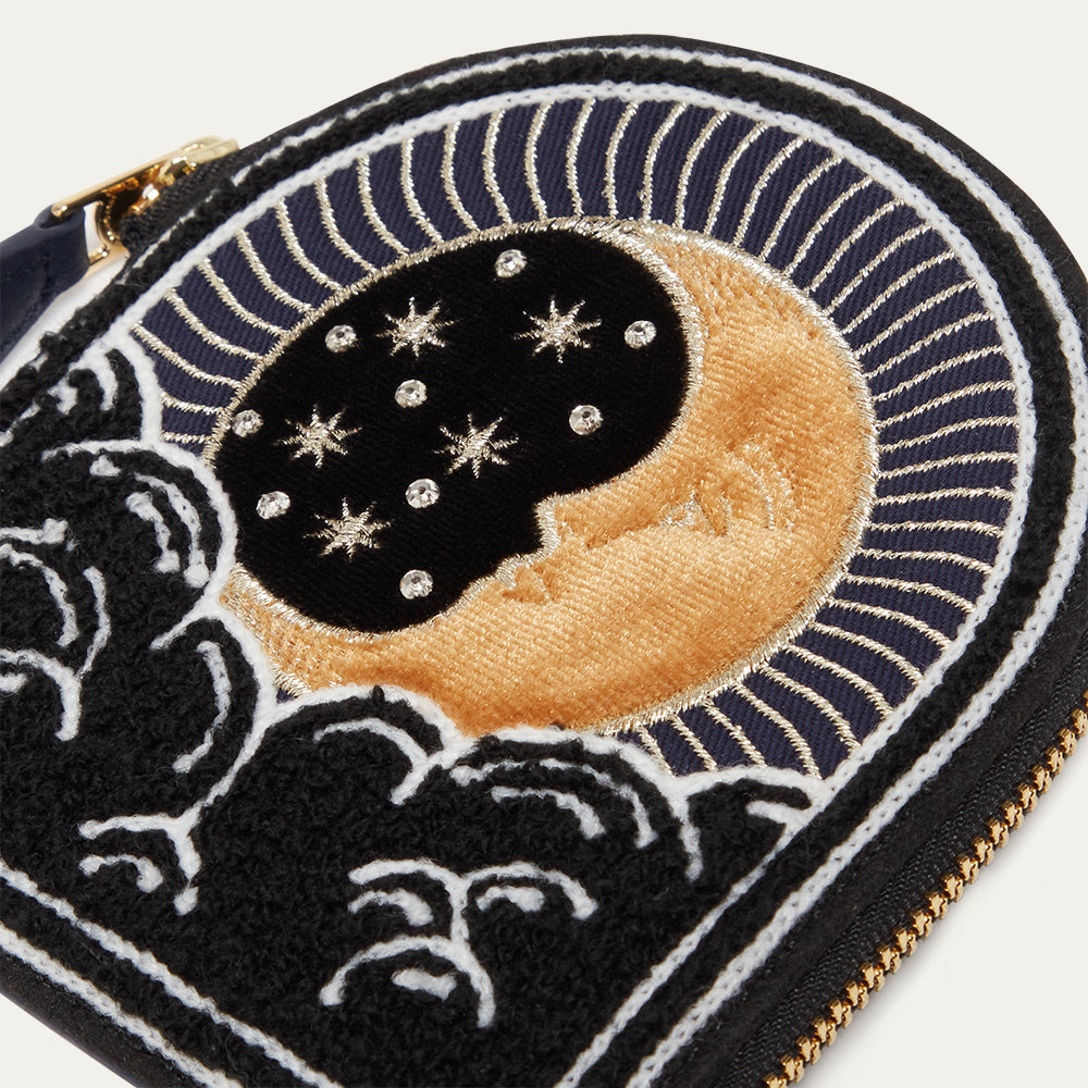 Embroidered coin purse with moon, stars, and cloud design on a white background