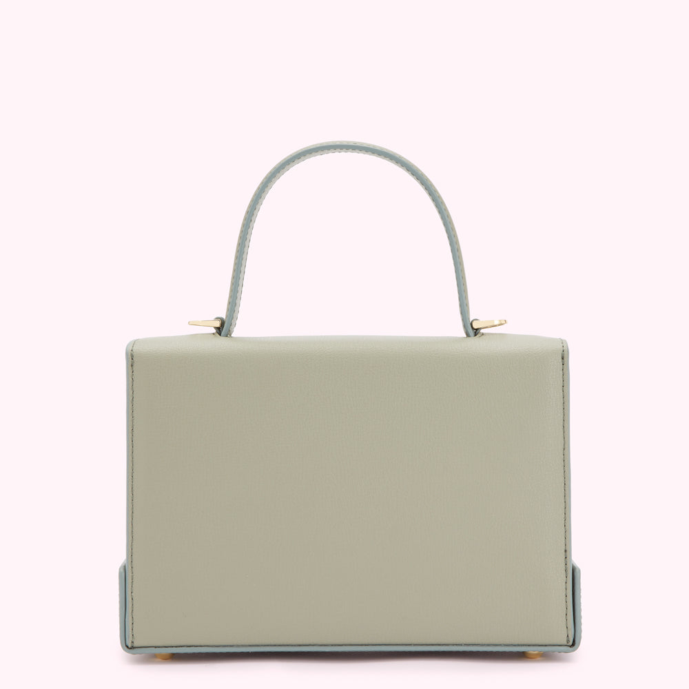 Sage green leather handbag with light blue handles and gold hardware, shown against a white background.
