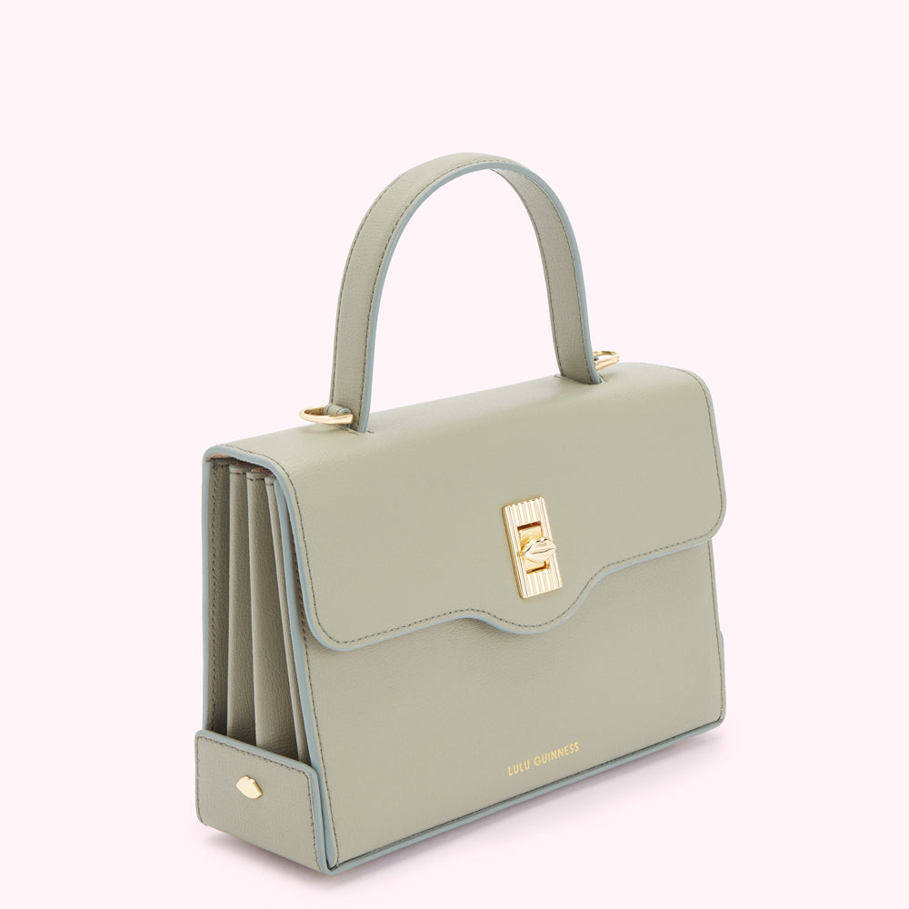 Sage green Lulu Guinness handbag with gold clasp.
