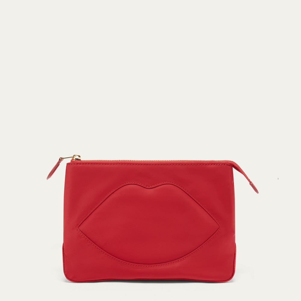 A red leather zip pouch featuring an embossed lips design on the front, with gold-tone zipper pulls, shown against a plain off-white background.