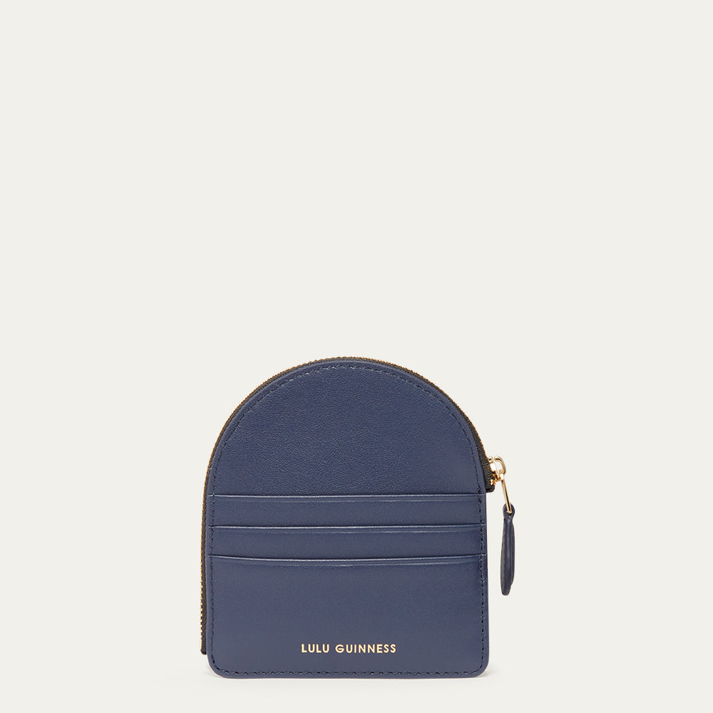 Navy blue coin purse with gold zipper on a light gray background
