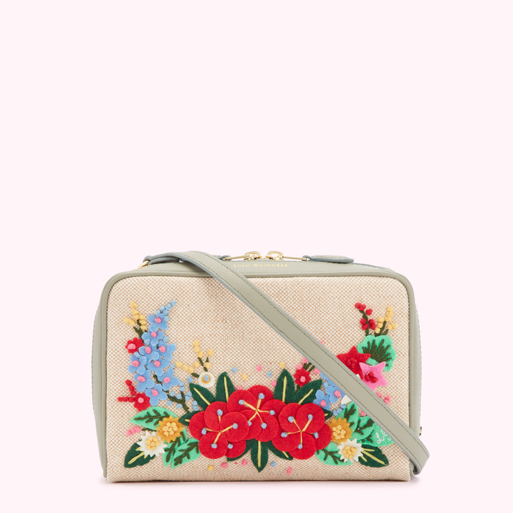 Sage green crossbody bag with embroidered flowers.