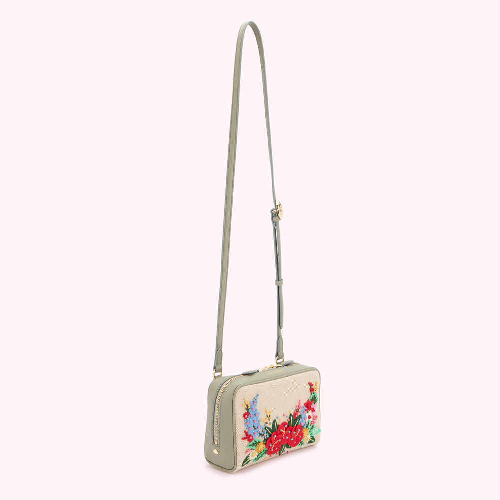 Sage green crossbody bag with a beige front panel featuring colourful embroidered flowers.
