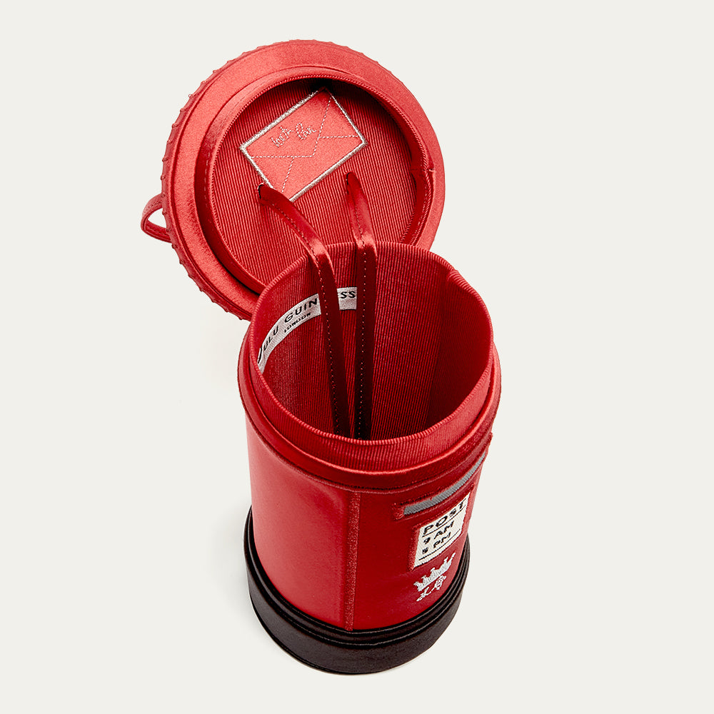 Red satin postbox shaped handbag with a open lid revealing the inside on a white background