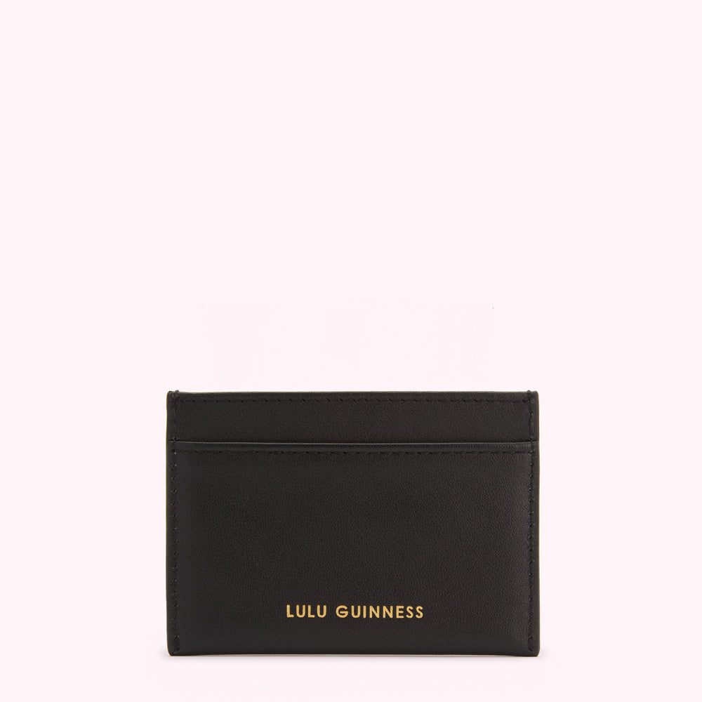 Black leather cardholder with gold Lulu Guinness logo on a white background.
