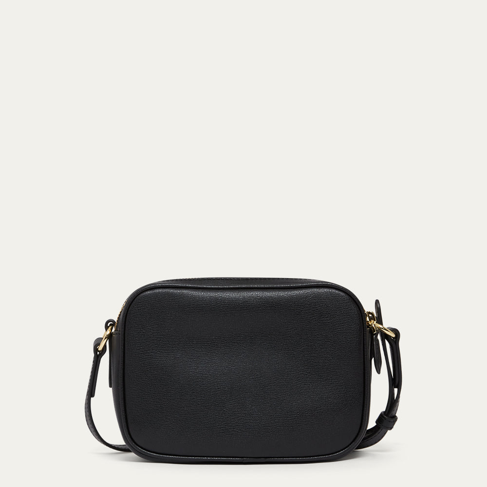 Black leather crossbody bag on a light grey background