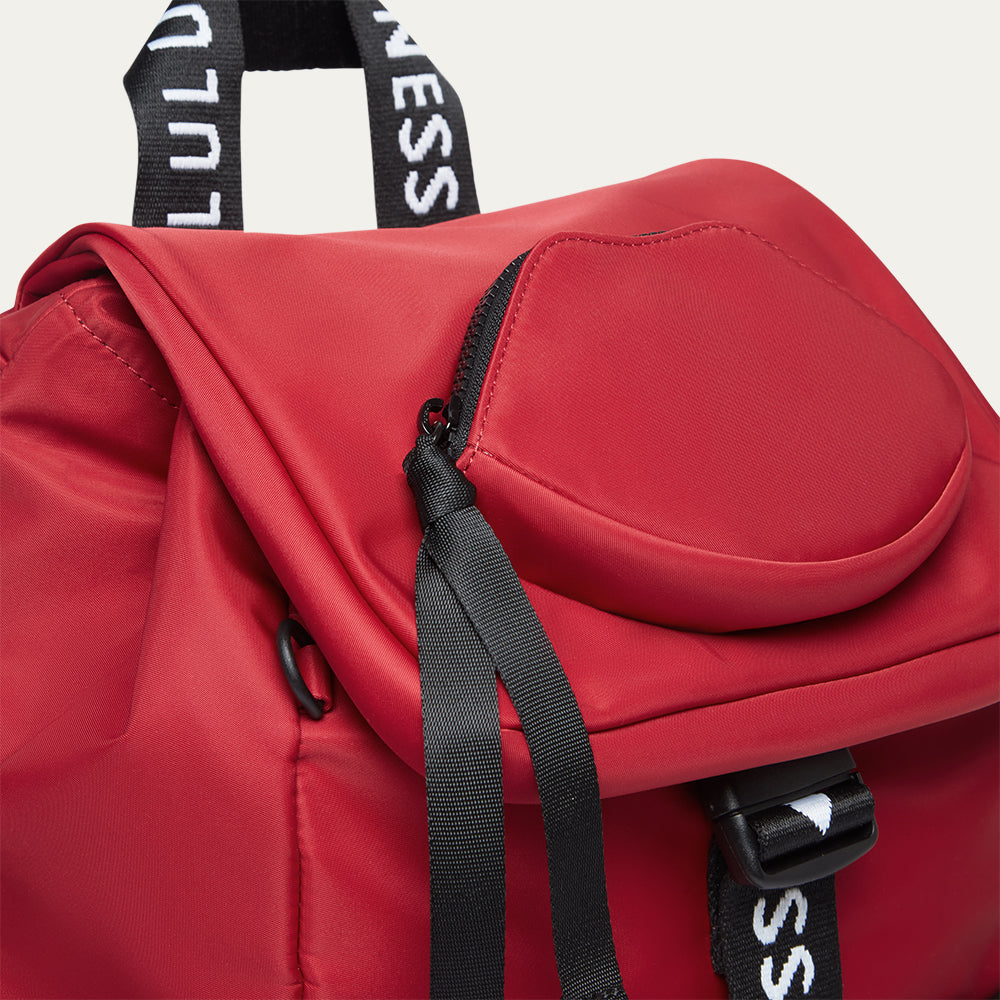 Red backpack with black straps and a lip-shaped pocket on a white background