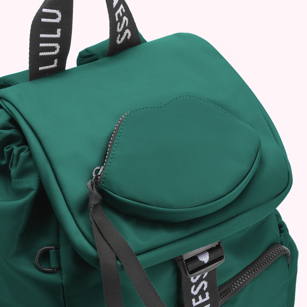 Close-up of a green backpack with a lip-shaped pocket and black accents.