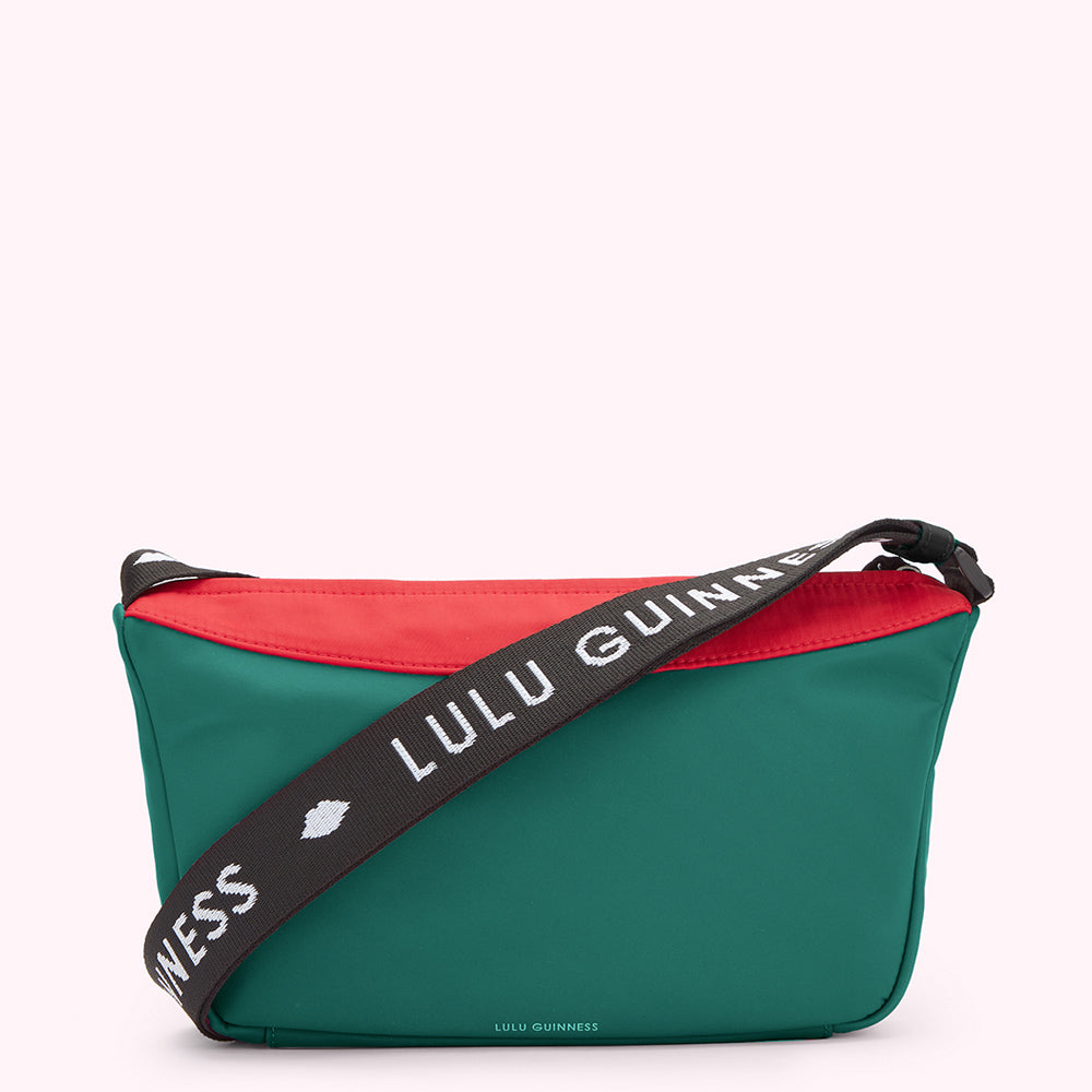 Green, red and black nylon crossbody bag with "Lulu Guinness" printed on the strap.