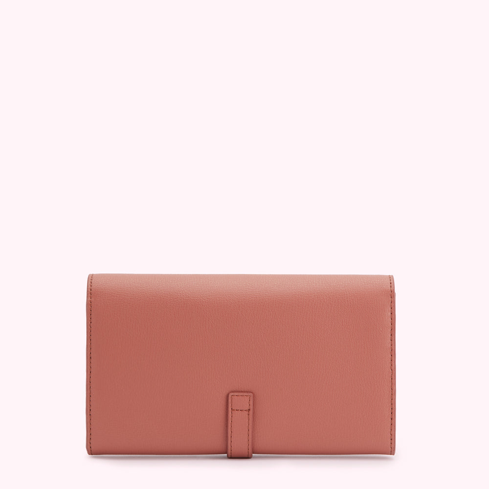Dusty rose leather wallet on white background.
