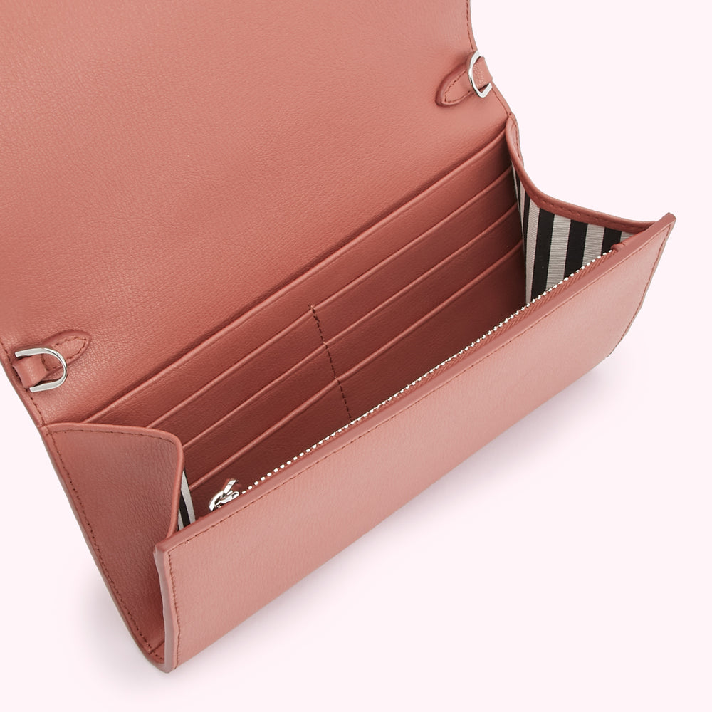 Dusty rose leather wallet open to reveal multiple card slots and a zippered compartment. The interior lining is black and white striped.
