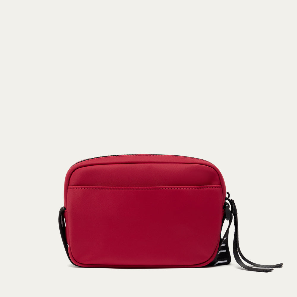 Red crossbody bag on a light grey background