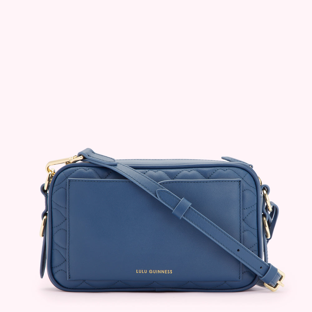 A quilted blue crossbody bag by Lulu Guinness.

