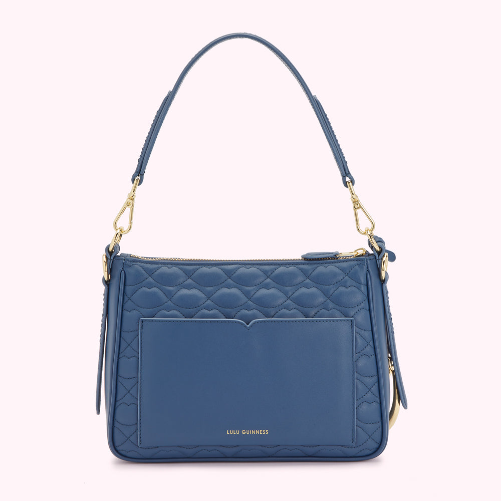 A blue quilted Lulu Guinness shoulder bag with gold hardware.
