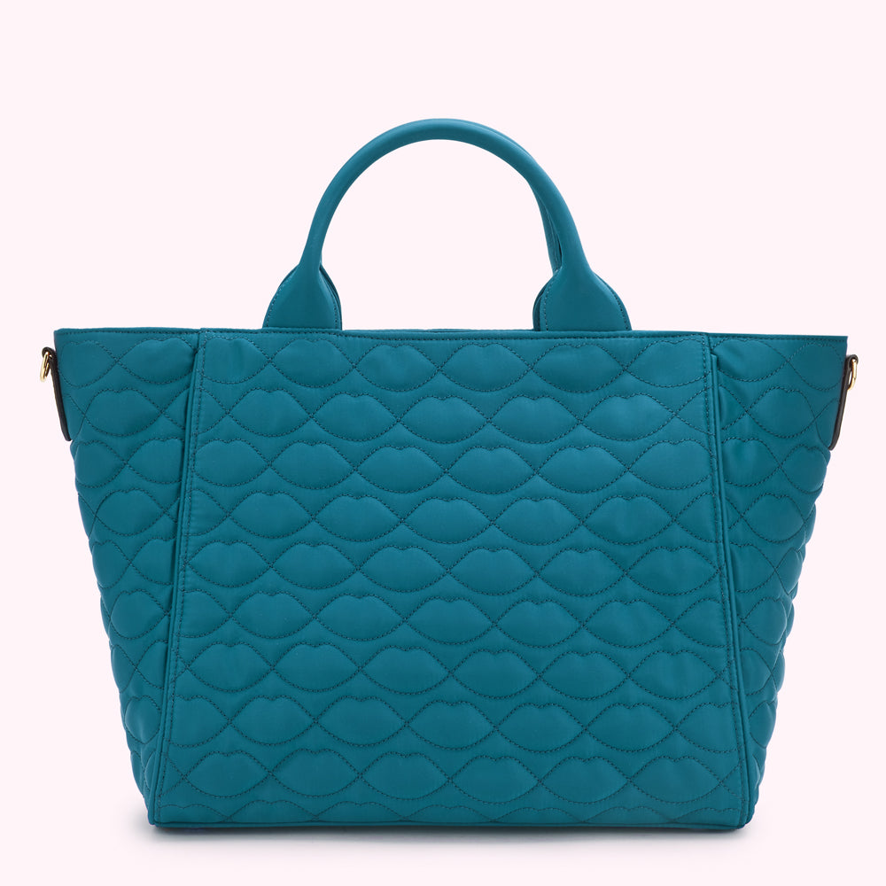 Teal quilted tote bag with lip-shaped pattern.
