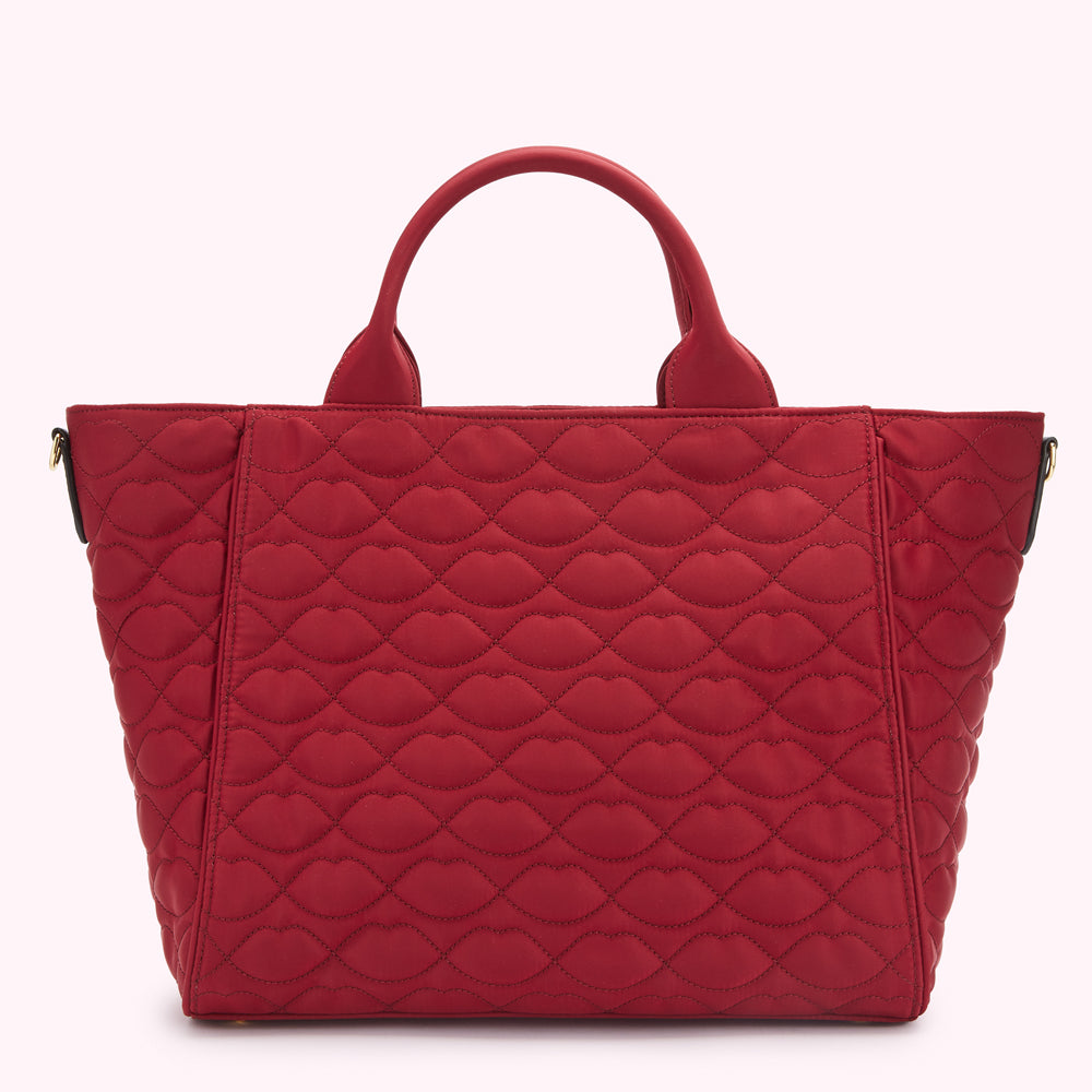 Red quilted tote bag with lip print.