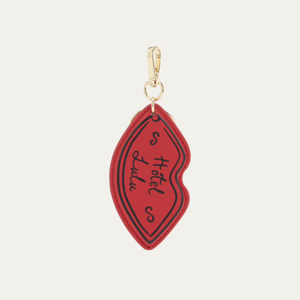 A red leather lip shaped keyring with 'Hotel Lulu' printed on the front.