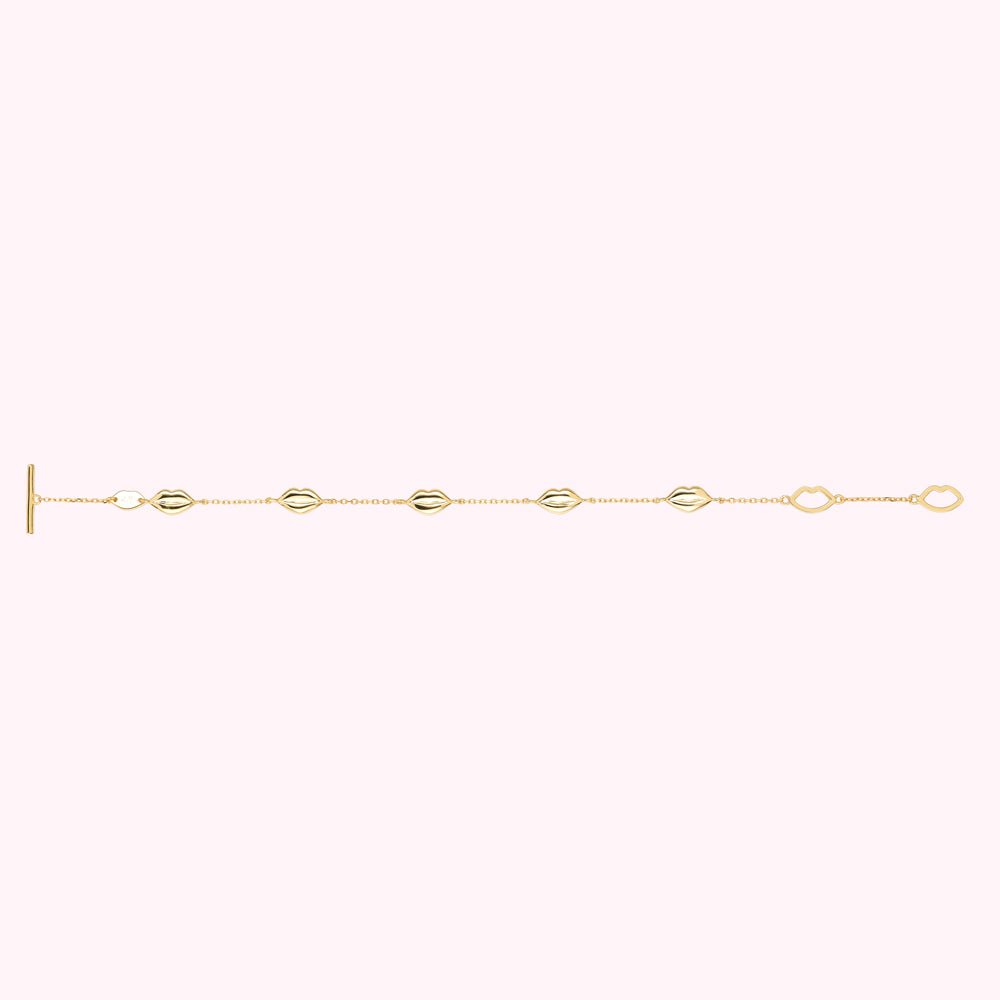 Flat shot of a gold plated sterling silver lip charm bracelet with lip shaped links.