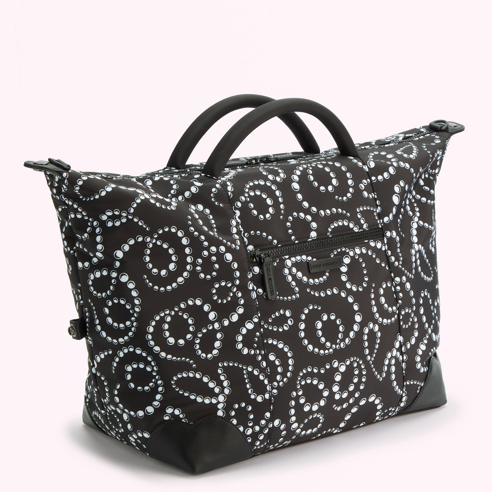 Black and white pearl pattern holdall bag with black handles.