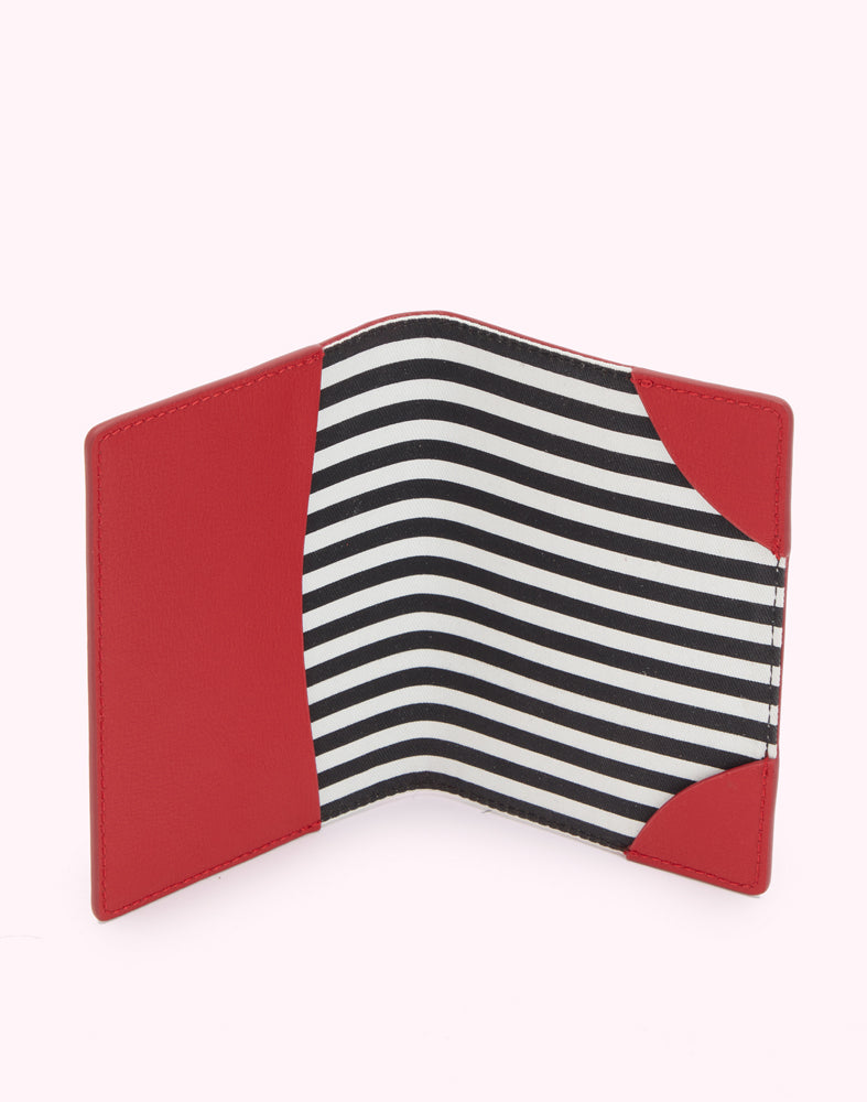 Inside image of a red leather passport cover showing the striped black and white lining.