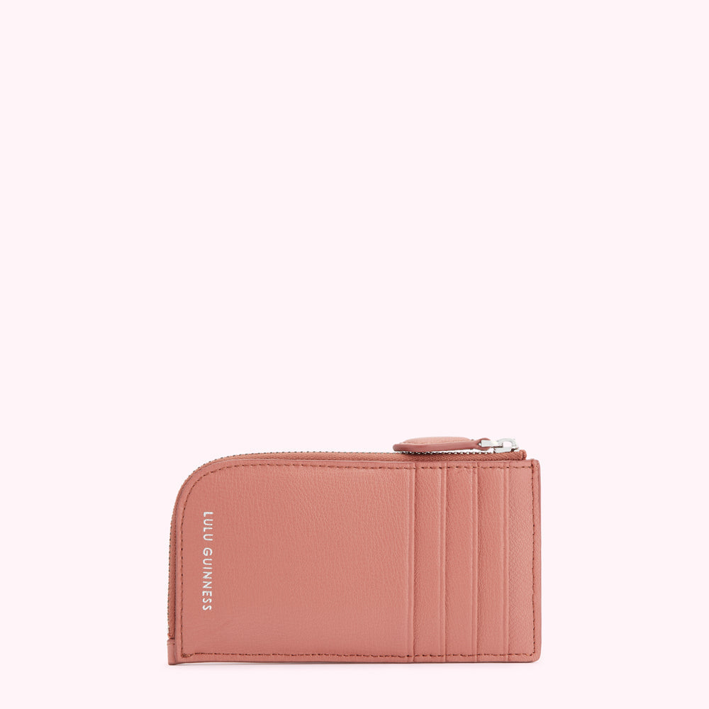 Dusty rose pink Lulu Guinness zip-around card holder against a white background.
