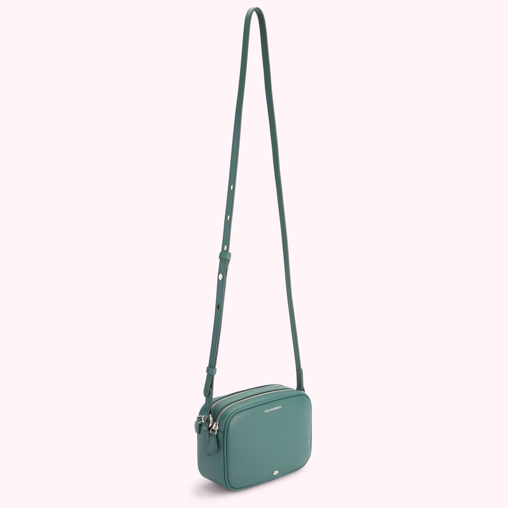 Teal crossbody bag with long strap.