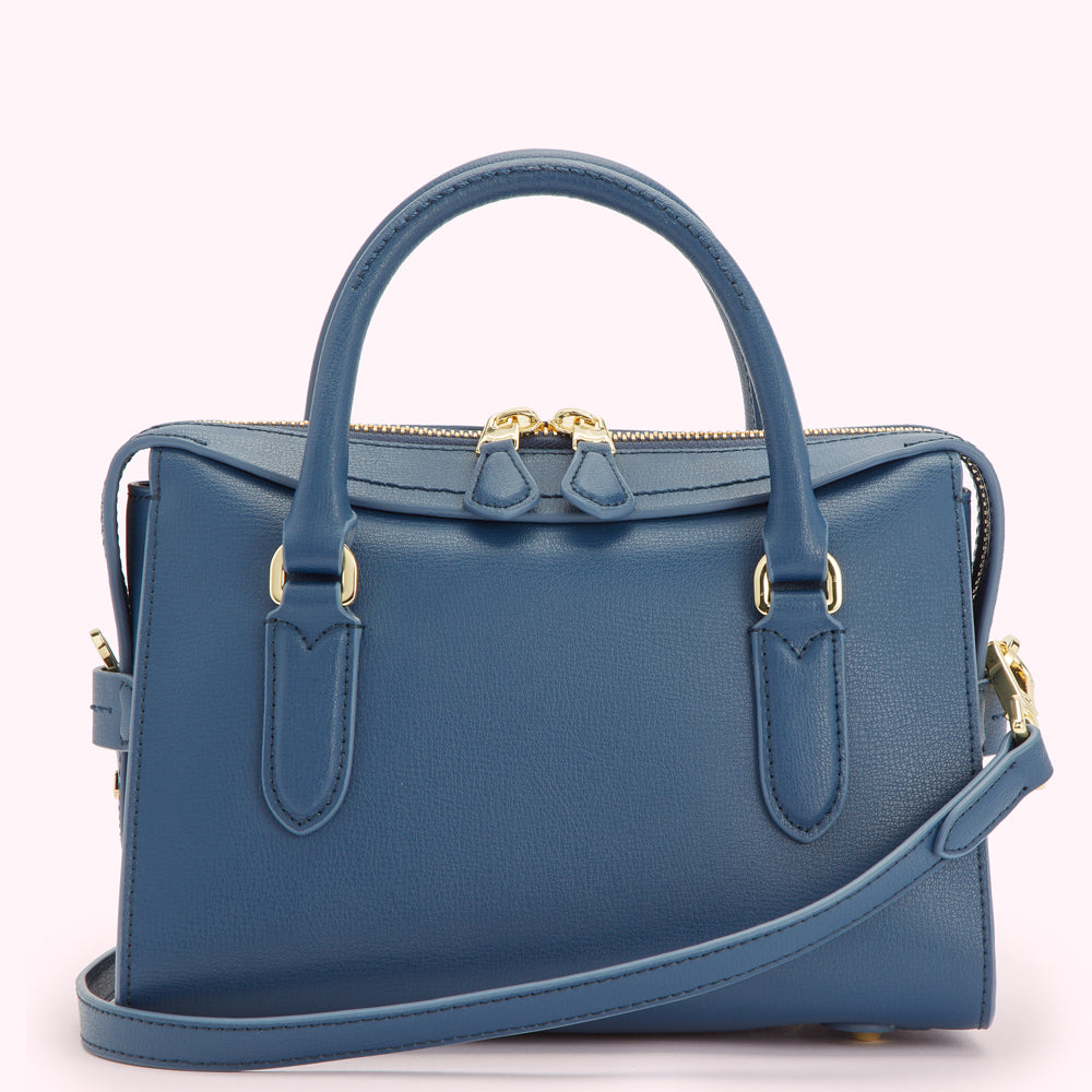A blue leather handbag with gold hardware and a detachable shoulder strap.
