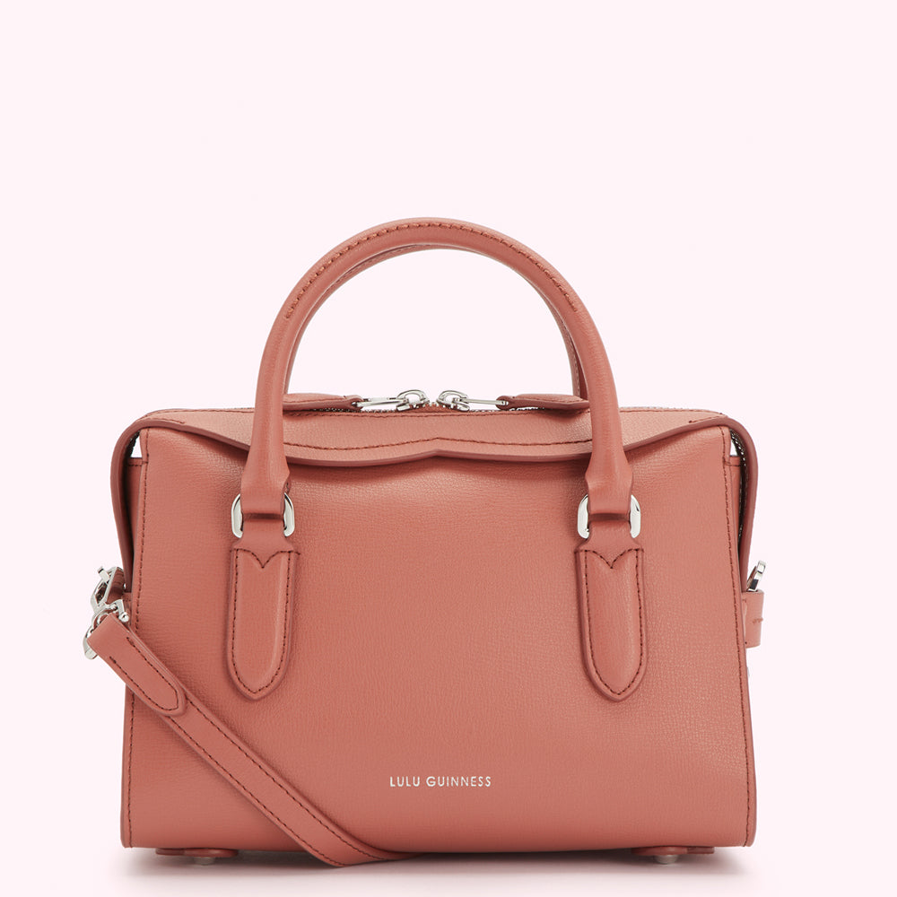 Dusty rose Lulu Guinness satchel bag with silver hardware and shoulder strap.
