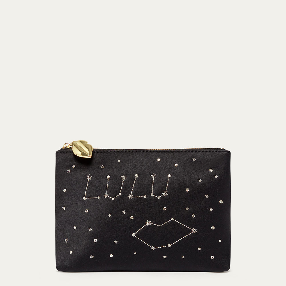 Black satin pouch with star constellation design and 'LULU' branding on a light gray background