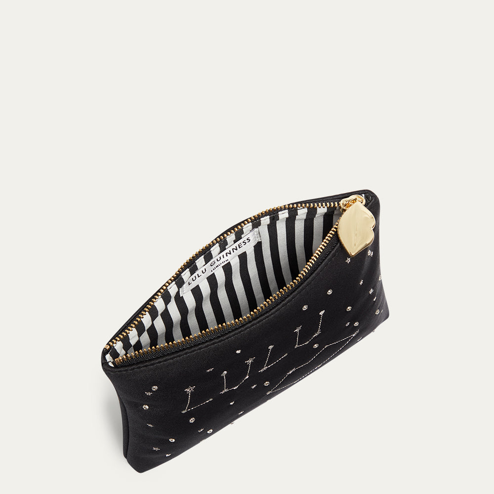 Black satin pouch with gold accents and striped interior on a light gray background