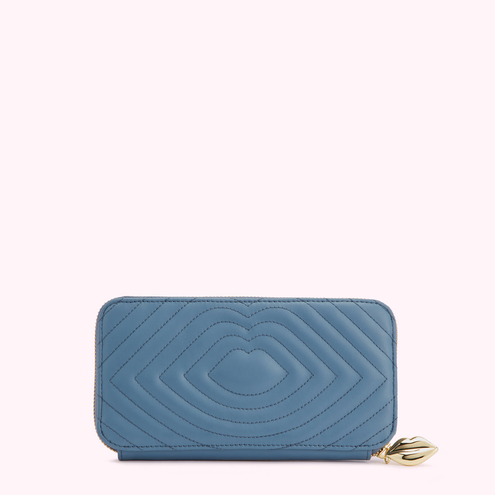 Blue quilted zip-around wallet with gold lip-shaped zipper pull.
