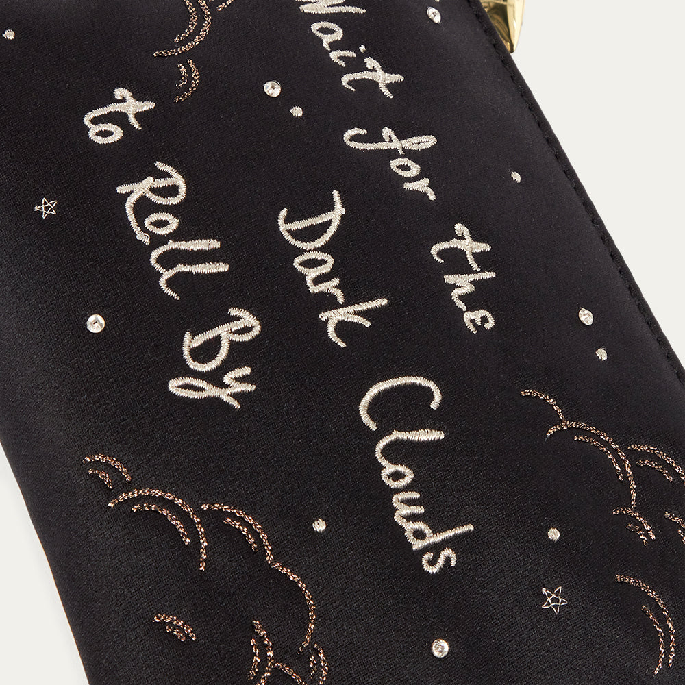 Black satin pouch with white text and decorative elements on a white background