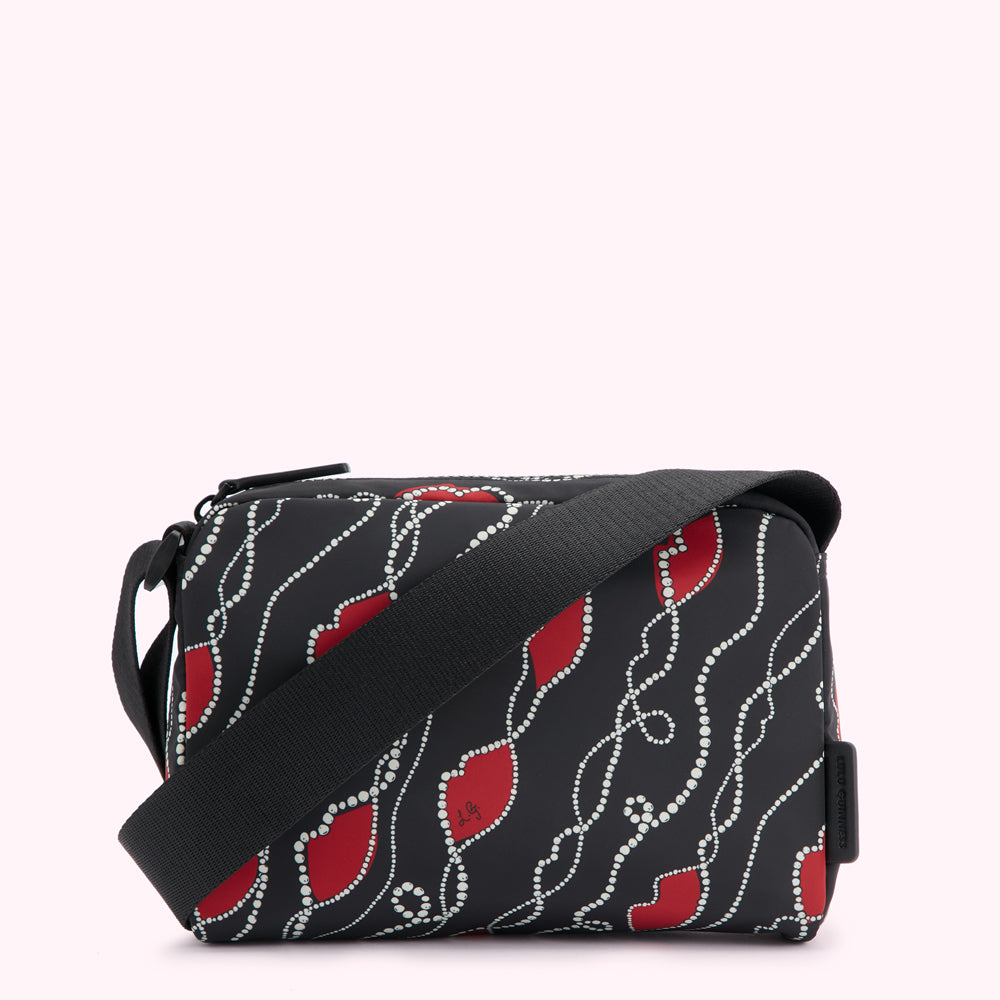 Black crossbody bag with red lips and pearl necklace pattern.