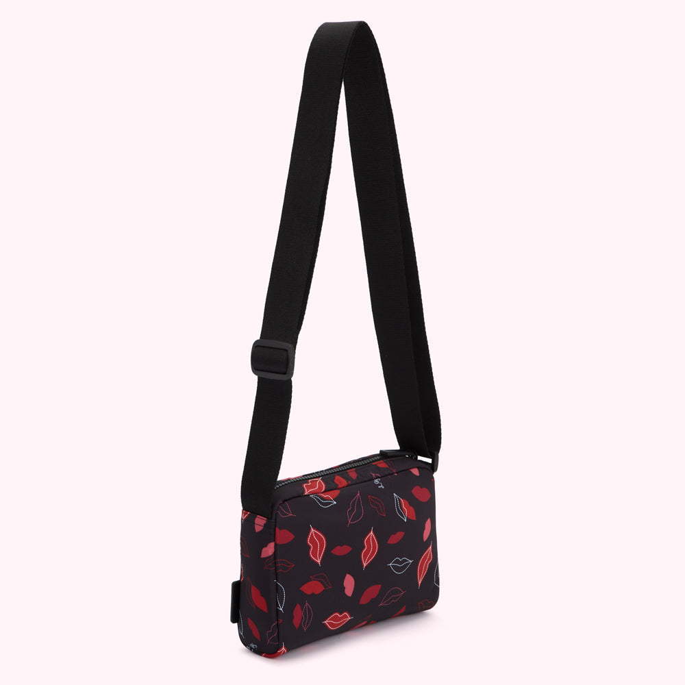 Black crossbody bag with a red and pink lips pattern.