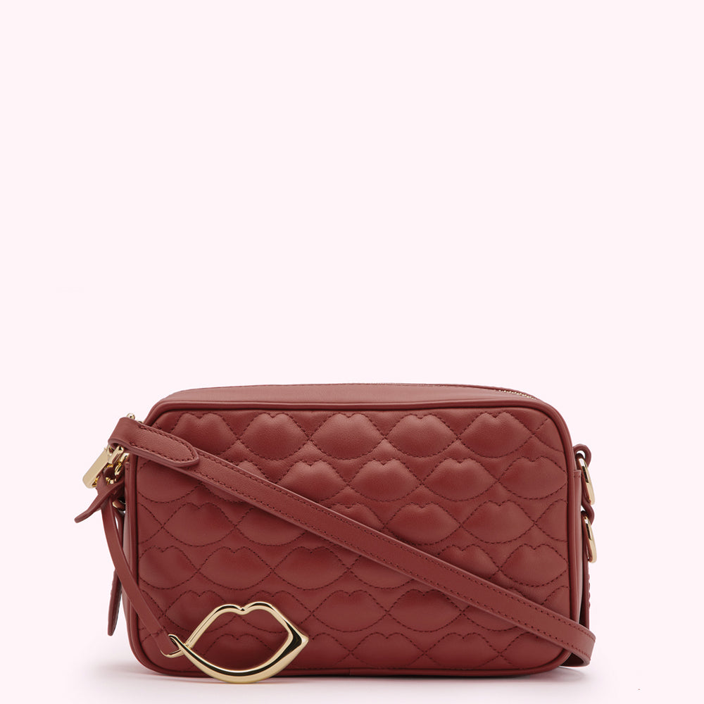 Grab 25% off at Lulu Guinness 2 A rust-coloured quilted crossbody bag with a gold lip-shaped accent.