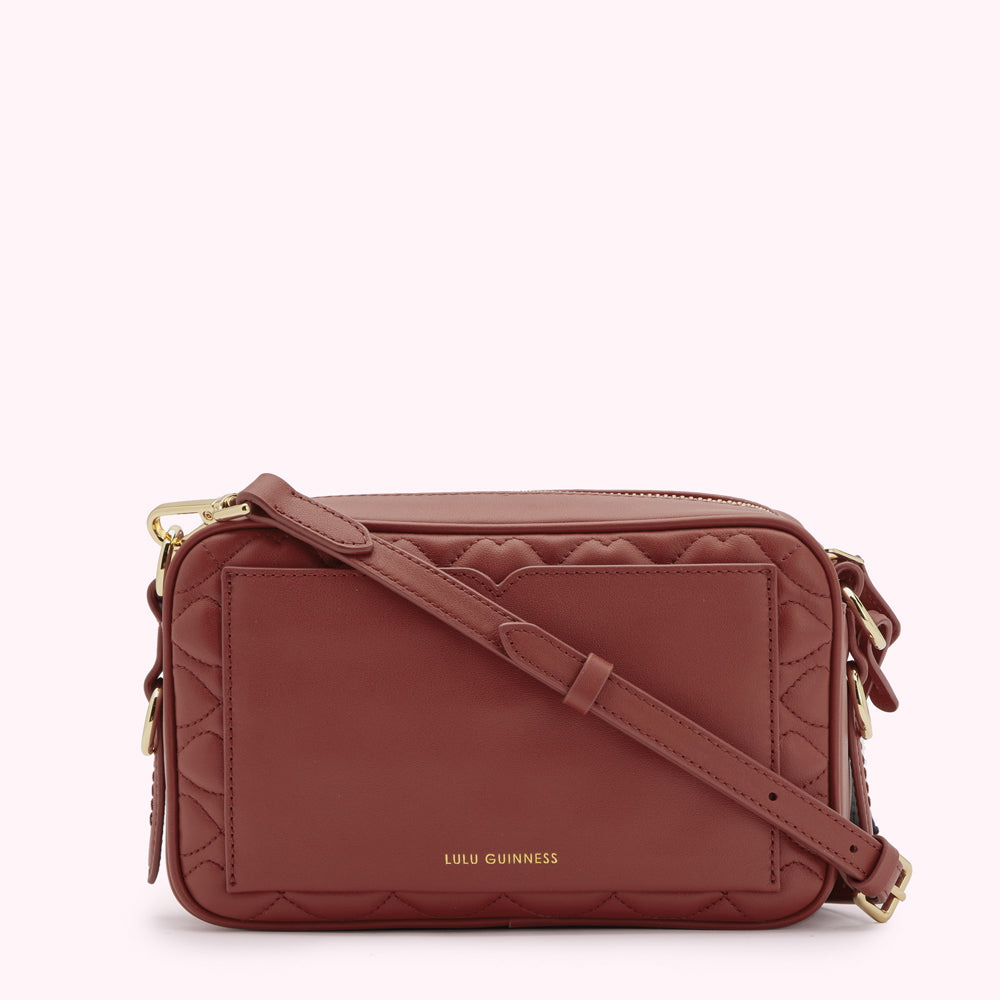 A brown quilted crossbody bag by Lulu Guinness.
