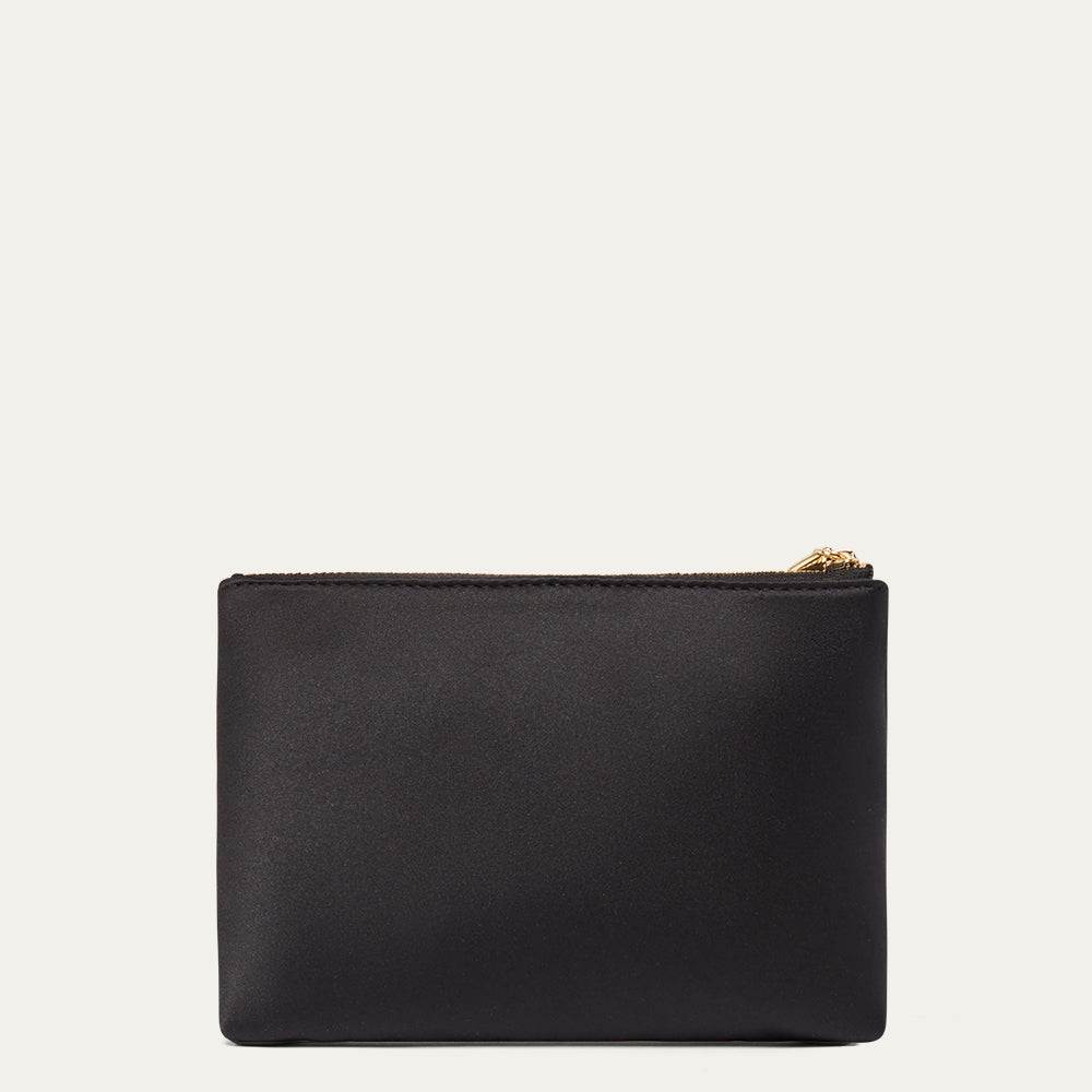 Black satin pouch with gold zipper on a light gray background