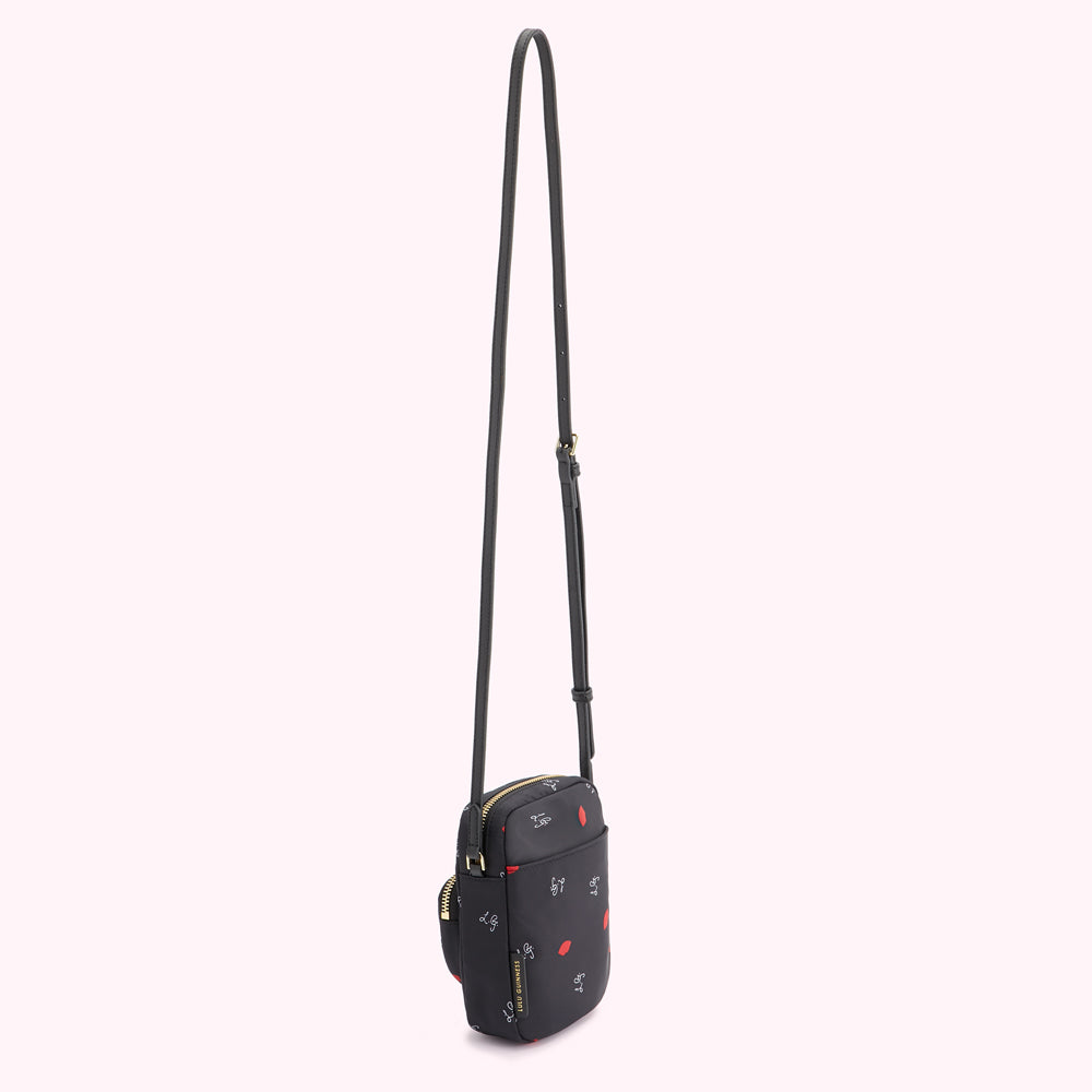 Black crossbody bag with red lips and white lettering print on a white background.