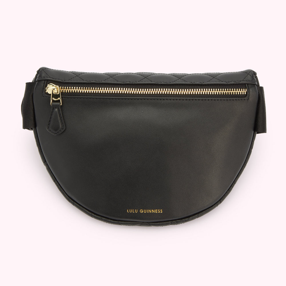 A back image of a black leather belt bag showing a hidden zipped pocket and a gold foil print Lulu Guinness logo.