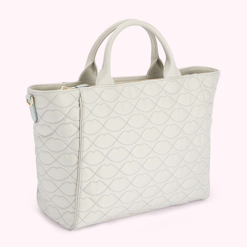 Light grey quilted tote bag with lip-shaped pattern.
