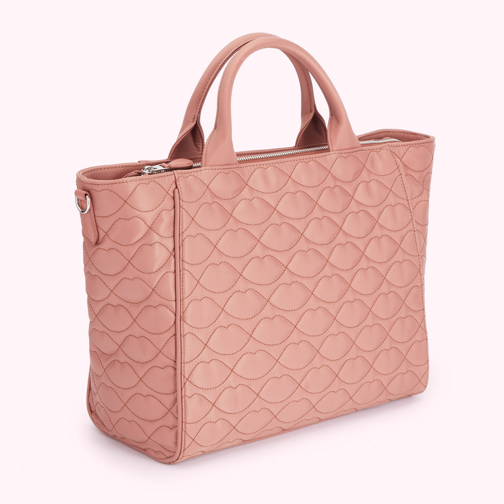 Dusty rose quilted handbag with lip print.
