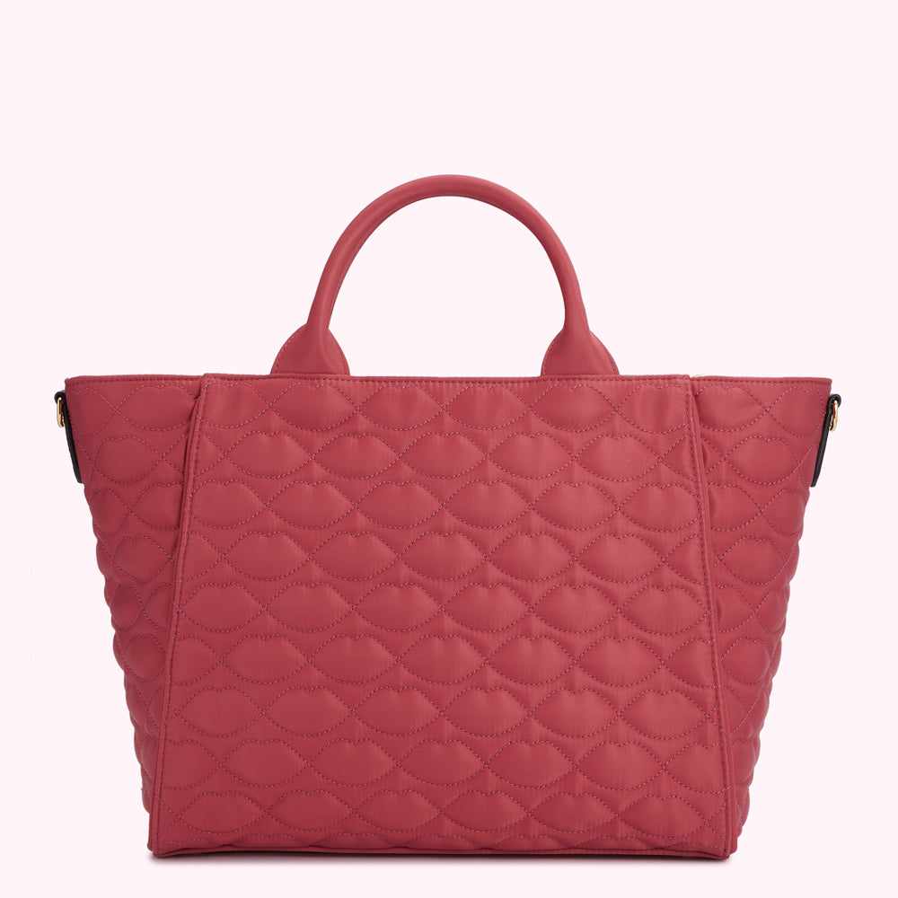 Red quilted tote bag with lip-shaped pattern.
