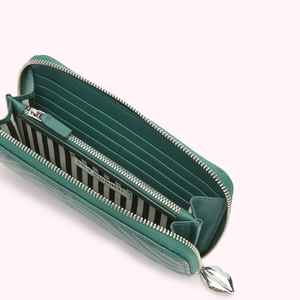 Open teal quilted leather zip-around wallet with silver-tone zipper and charm.