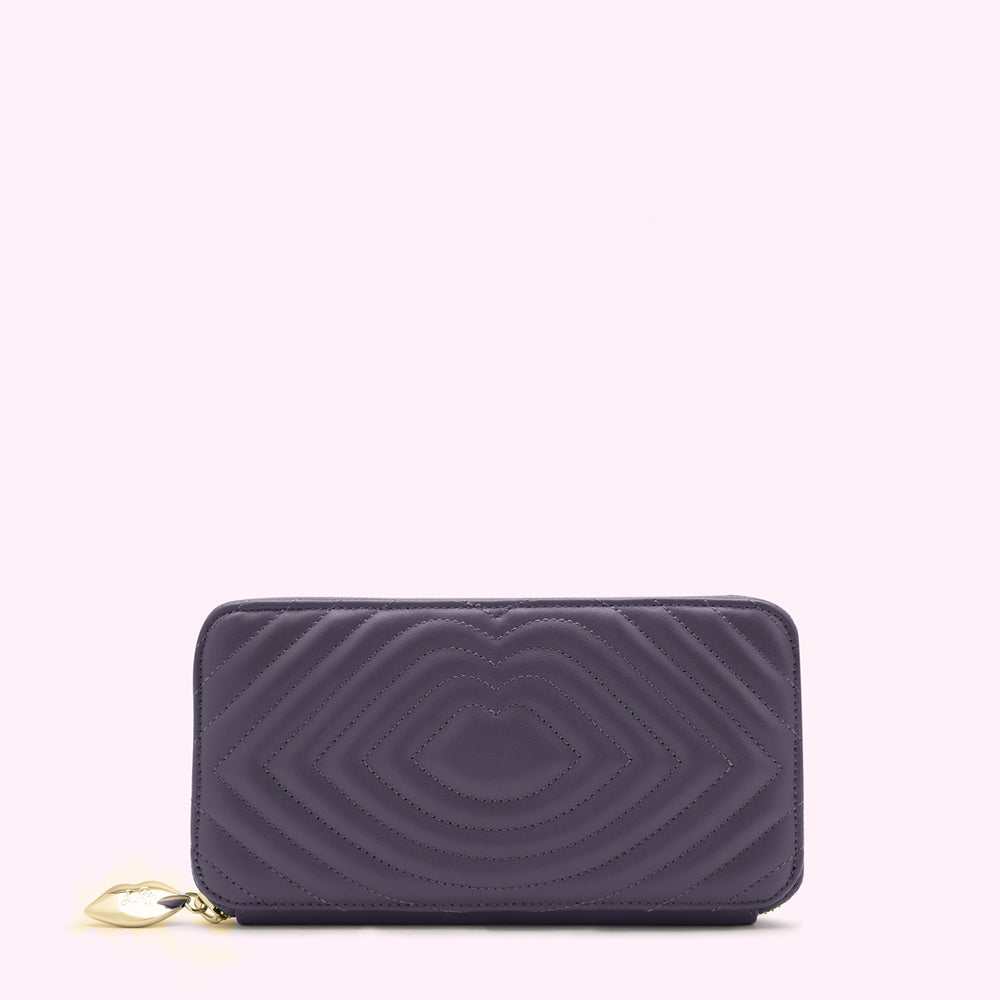 Purple quilted zip-around wallet with a gold charm.
