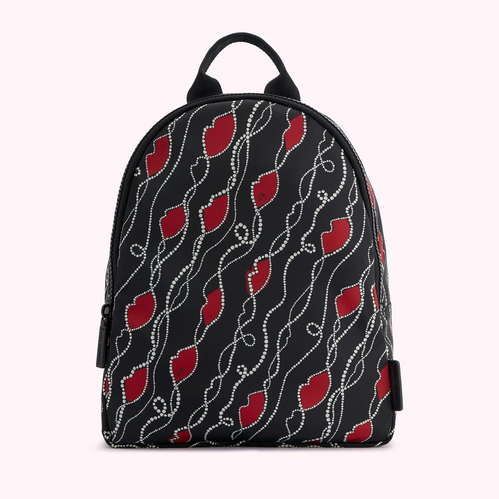 Black backpack with red lips and white pearls pattern.