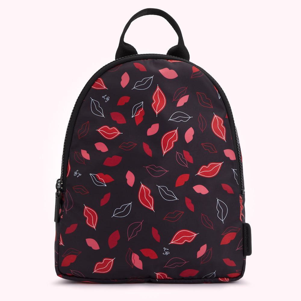 Black backpack with a red and pink lip print.