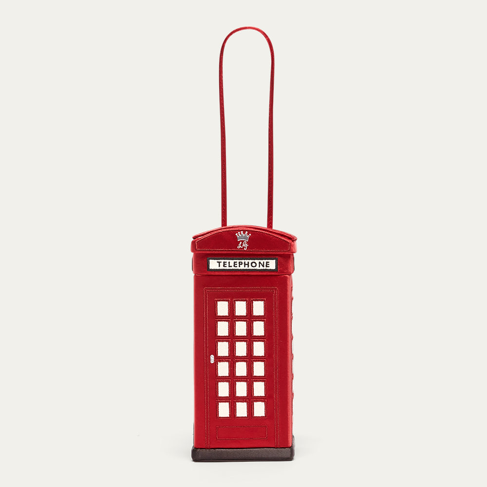Red telephone box-shaped product with a handle on a light gray background