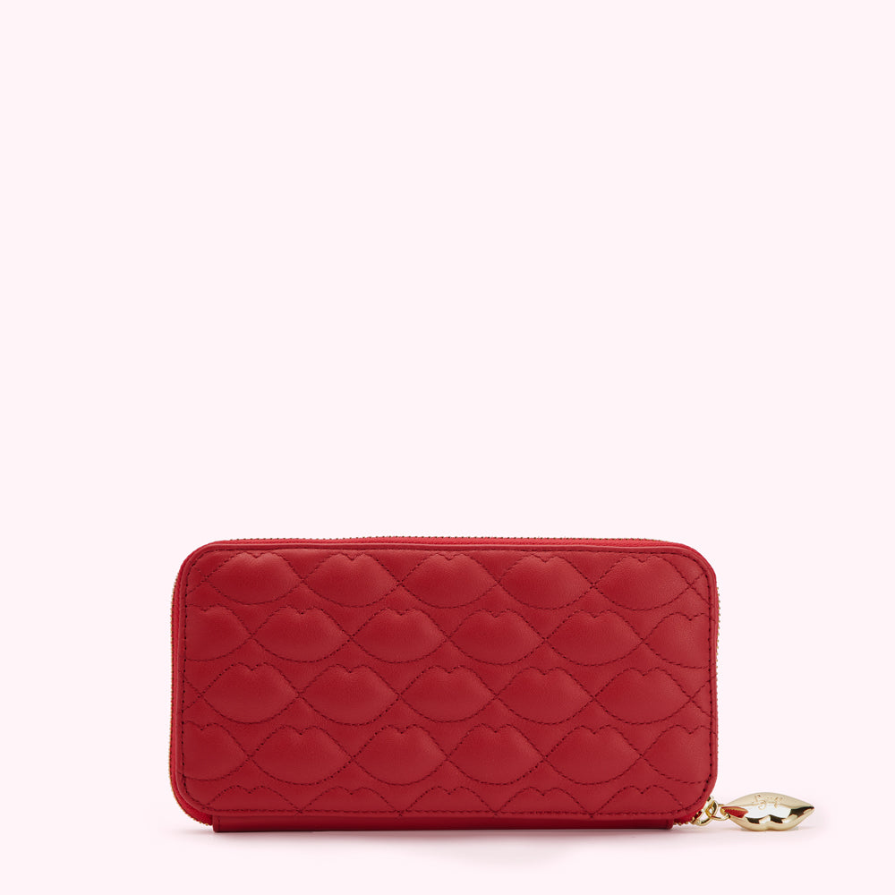 Red quilted zip-around wallet with lip pattern.
