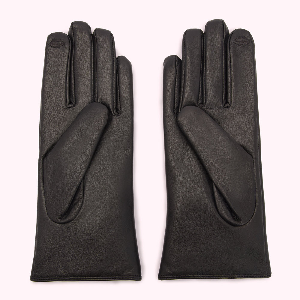 Pair of black leather gloves on a white background.