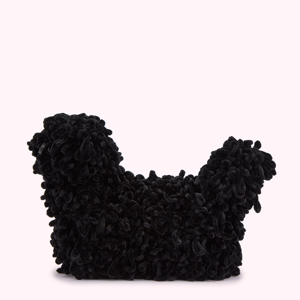Black velvet dog-shaped bag with textured curly detailing, displayed against a light pink background